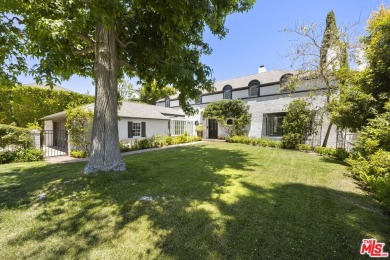 Tucked behind lush landscaping on one of the most coveted and on Los Angeles Country Club in California - for sale on GolfHomes.com, golf home, golf lot