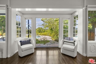 Tucked behind lush landscaping on one of the most coveted and on Los Angeles Country Club in California - for sale on GolfHomes.com, golf home, golf lot