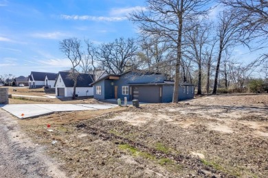 Nestled between Cedar Creek Country Club (golf packages on Cedar Creek Country Club in Texas - for sale on GolfHomes.com, golf home, golf lot