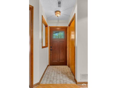 Unique open floor plan.  Living room featuring a vaulted ceiling on Alvamar Country Club in Kansas - for sale on GolfHomes.com, golf home, golf lot