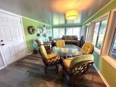 This charming cottage-style home radiates the essence of a sunny on Crystal Lake Club in Florida - for sale on GolfHomes.com, golf home, golf lot