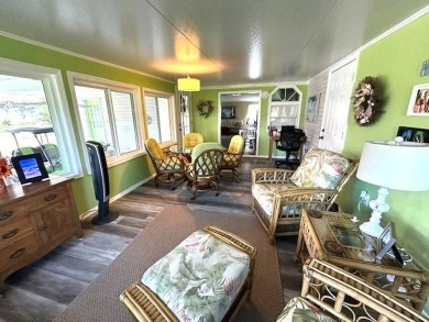 This charming cottage-style home radiates the essence of a sunny on Crystal Lake Club in Florida - for sale on GolfHomes.com, golf home, golf lot