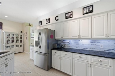 Beautifully updated 1994 Palmwood Bahama Breeze courtyard pool on Glen Lakes Country Club in Florida - for sale on GolfHomes.com, golf home, golf lot