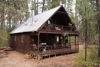 Among the serene wooded pines, this cozy, rustic cabin is a on Terrace Lakes Golf Resort in Idaho - for sale on GolfHomes.com, golf home, golf lot