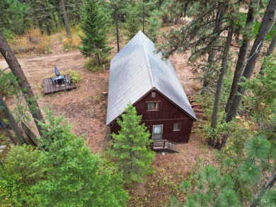 Among the serene wooded pines, this cozy, rustic cabin is a on Terrace Lakes Golf Resort in Idaho - for sale on GolfHomes.com, golf home, golf lot