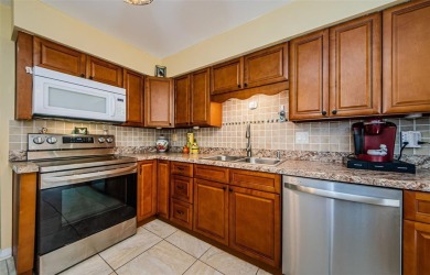 Under contract-accepting backup offers. STUNNING FIRST FLOOR on Gulf Harbors Golf Course in Florida - for sale on GolfHomes.com, golf home, golf lot