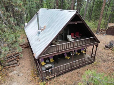 Among the serene wooded pines, this cozy, rustic cabin is a on Terrace Lakes Golf Resort in Idaho - for sale on GolfHomes.com, golf home, golf lot