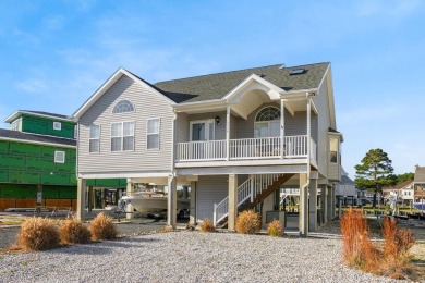 Waterfront house with paved area underneath and nice landscaping on Captains Cove Golf and Yacht Club in Virginia - for sale on GolfHomes.com, golf home, golf lot