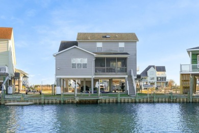 Waterfront house with paved area underneath and nice landscaping on Captains Cove Golf and Yacht Club in Virginia - for sale on GolfHomes.com, golf home, golf lot