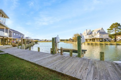 Waterfront house with paved area underneath and nice landscaping on Captains Cove Golf and Yacht Club in Virginia - for sale on GolfHomes.com, golf home, golf lot