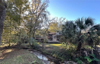 Charming 3-bedroom retreat with creekside views in Turkey Creek on Turkey Creek Golf and Country Club in Florida - for sale on GolfHomes.com, golf home, golf lot