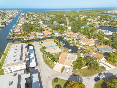 Welcome to this inviting waterfront community, where a tropical on Gulf Harbors Golf Course in Florida - for sale on GolfHomes.com, golf home, golf lot