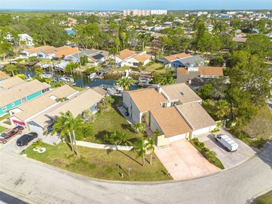 Welcome to this inviting waterfront community, where a tropical on Gulf Harbors Golf Course in Florida - for sale on GolfHomes.com, golf home, golf lot