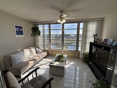 Bright and Stunning Corner unit with lake & Golf views, located on Oriole Golf and Tennis Club in Florida - for sale on GolfHomes.com, golf home, golf lot