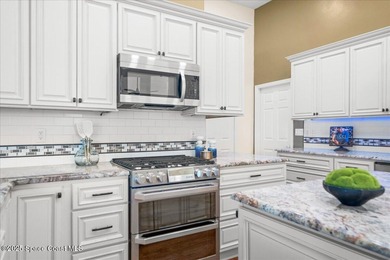 Step into this beautifully maintained pool home in the coveted on Viera East Golf Club in Florida - for sale on GolfHomes.com, golf home, golf lot