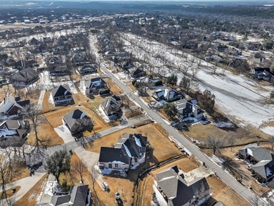 Impressive curb appeal welcomes you from the moment you arrive on Pecan Plantation Country Club in Texas - for sale on GolfHomes.com, golf home, golf lot