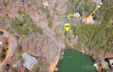 Discover a rare opportunity to craft your luxury lake retreat in on Rumbling Bald Resort on Lake Lure in North Carolina - for sale on GolfHomes.com, golf home, golf lot
