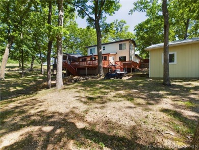 Welcome to 32280 Gliding Hawk, where modern luxury meets serene on Indian Rock Golf Club in Missouri - for sale on GolfHomes.com, golf home, golf lot