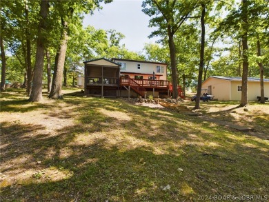 Welcome to 32280 Gliding Hawk, where modern luxury meets serene on Indian Rock Golf Club in Missouri - for sale on GolfHomes.com, golf home, golf lot