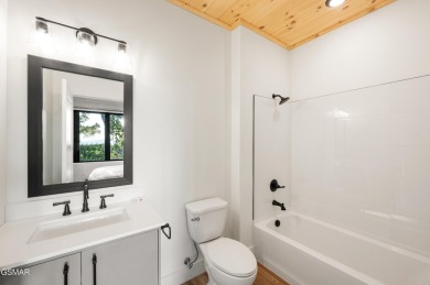 This newly constructed, fully furnished 4-bedroom, 4.5-bathroom on Sevierville Golf Club in Tennessee - for sale on GolfHomes.com, golf home, golf lot