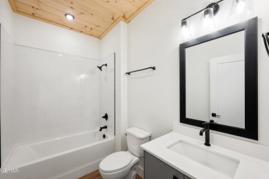 This newly constructed, fully furnished 4-bedroom, 4.5-bathroom on Sevierville Golf Club in Tennessee - for sale on GolfHomes.com, golf home, golf lot