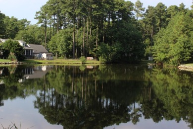 1/1148 Level, wooded lot that overlooks a tidal pond that has on Captains Cove Golf and Yacht Club in Virginia - for sale on GolfHomes.com, golf home, golf lot