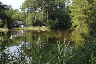 1/1148 Level, wooded lot that overlooks a tidal pond that has on Captains Cove Golf and Yacht Club in Virginia - for sale on GolfHomes.com, golf home, golf lot