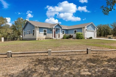 This beautifully designed stone home with blue and red accents on Lighthouse Golf Course in Texas - for sale on GolfHomes.com, golf home, golf lot