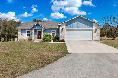 This beautifully designed stone home with blue and red accents on Lighthouse Golf Course in Texas - for sale on GolfHomes.com, golf home, golf lot