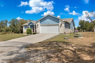 This beautifully designed stone home with blue and red accents on Lighthouse Golf Course in Texas - for sale on GolfHomes.com, golf home, golf lot