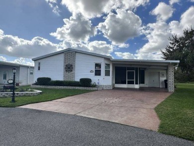 This beautiful triple-wide home, located on the golf course on Four Lakes Golf Club in Florida - for sale on GolfHomes.com, golf home, golf lot