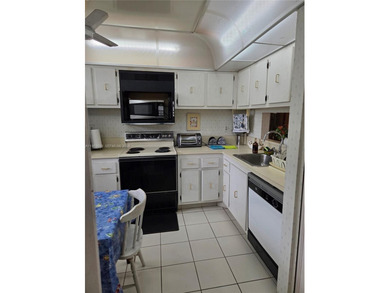 Spacious 2-bedroom, 2-bathroom second-floor condo located in a on Colony West Country Club in Florida - for sale on GolfHomes.com, golf home, golf lot