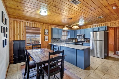 Warm, welcoming, and full of character, this log cabin style on De Cordova Bend Country Club in Texas - for sale on GolfHomes.com, golf home, golf lot