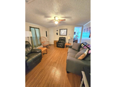 Imagine driving down a beautiful tree-lined street in a secure on Crystal Lake Club in Florida - for sale on GolfHomes.com, golf home, golf lot