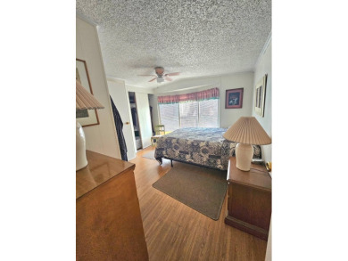 Imagine driving down a beautiful tree-lined street in a secure on Crystal Lake Club in Florida - for sale on GolfHomes.com, golf home, golf lot