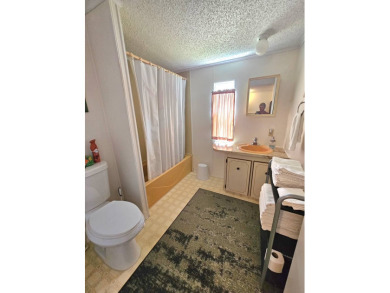 Imagine driving down a beautiful tree-lined street in a secure on Crystal Lake Club in Florida - for sale on GolfHomes.com, golf home, golf lot