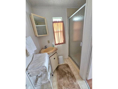 Imagine driving down a beautiful tree-lined street in a secure on Crystal Lake Club in Florida - for sale on GolfHomes.com, golf home, golf lot