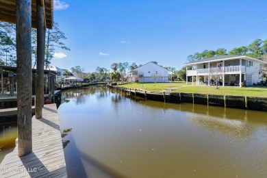 Enjoy this beautiful waterfront lot while planning your dream on Pass Christian Isles Golf Club in Mississippi - for sale on GolfHomes.com, golf home, golf lot