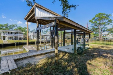 Enjoy this beautiful waterfront lot while planning your dream on Pass Christian Isles Golf Club in Mississippi - for sale on GolfHomes.com, golf home, golf lot
