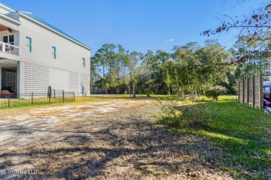 Enjoy this beautiful waterfront lot while planning your dream on Pass Christian Isles Golf Club in Mississippi - for sale on GolfHomes.com, golf home, golf lot