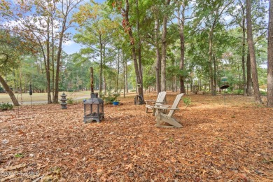 This beautiful home is nestled on a completely landscaped wooded on Lockwood Folly Country Club in North Carolina - for sale on GolfHomes.com, golf home, golf lot