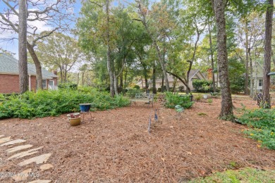 This beautiful home is nestled on a completely landscaped wooded on Lockwood Folly Country Club in North Carolina - for sale on GolfHomes.com, golf home, golf lot