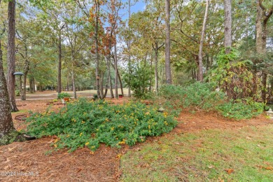 This beautiful home is nestled on a completely landscaped wooded on Lockwood Folly Country Club in North Carolina - for sale on GolfHomes.com, golf home, golf lot