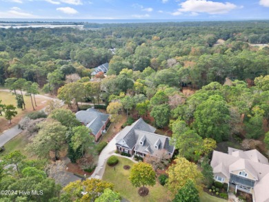 This beautiful home is nestled on a completely landscaped wooded on Lockwood Folly Country Club in North Carolina - for sale on GolfHomes.com, golf home, golf lot