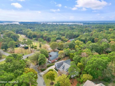 This beautiful home is nestled on a completely landscaped wooded on Lockwood Folly Country Club in North Carolina - for sale on GolfHomes.com, golf home, golf lot