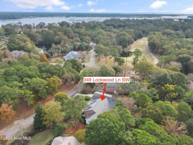 This beautiful home is nestled on a completely landscaped wooded on Lockwood Folly Country Club in North Carolina - for sale on GolfHomes.com, golf home, golf lot