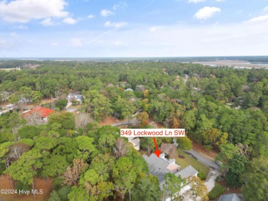 This beautiful home is nestled on a completely landscaped wooded on Lockwood Folly Country Club in North Carolina - for sale on GolfHomes.com, golf home, golf lot
