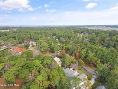 This beautiful home is nestled on a completely landscaped wooded on Lockwood Folly Country Club in North Carolina - for sale on GolfHomes.com, golf home, golf lot