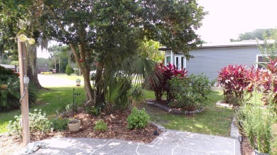 Discover the charm of this beautiful 2-bedroom Palm Harbor home on Schalamar Creek Golf and Country Club in Florida - for sale on GolfHomes.com, golf home, golf lot