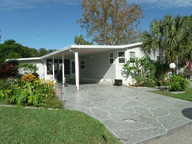 Discover the charm of this beautiful 2-bedroom Palm Harbor home on Schalamar Creek Golf and Country Club in Florida - for sale on GolfHomes.com, golf home, golf lot